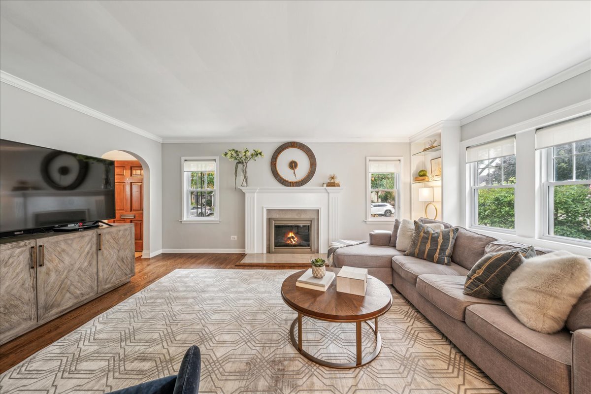212 E Road Glen Ellyn, IL 60137 - Photo 11 of 42 a living room with furniture a fireplace and a large window