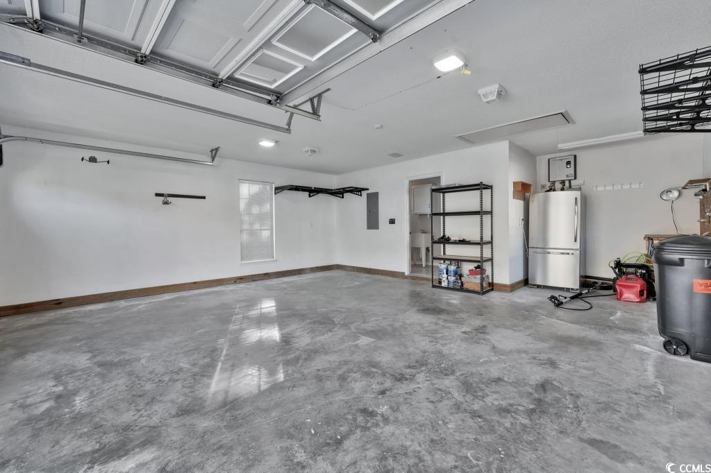 1639 Coventry Road Surfside Beach, SC 29575 - Photo 22 of 38 Garage with stainless steel refrigerator and electric panel