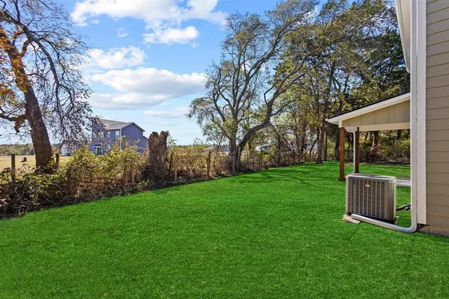 a view of backyard with a garden and entertaining space