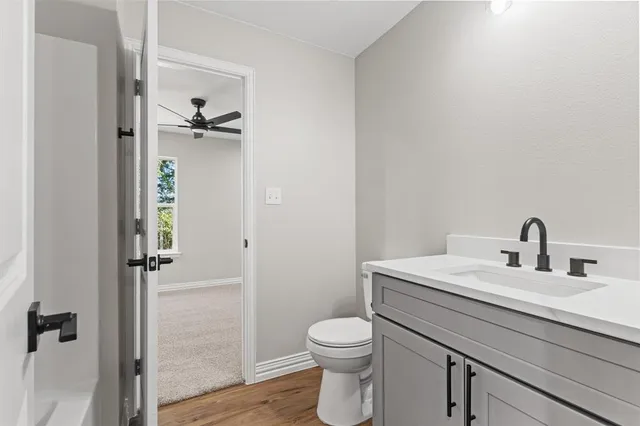 a bathroom with a toilet a sink and shower