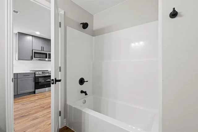 a bathroom with a bathtub and a sink