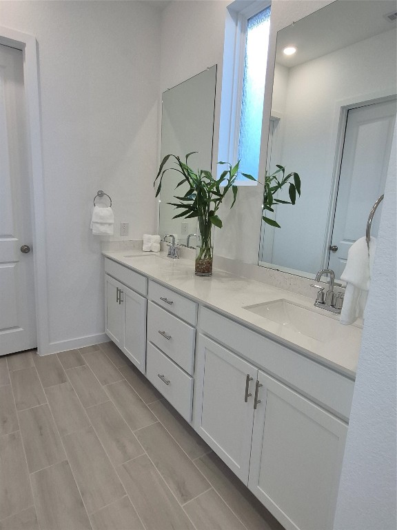 31007 Golden Felipe Street Fulshear, TX 77441 - Photo 12 of 19 a bathroom with a double vanity sink and mirror