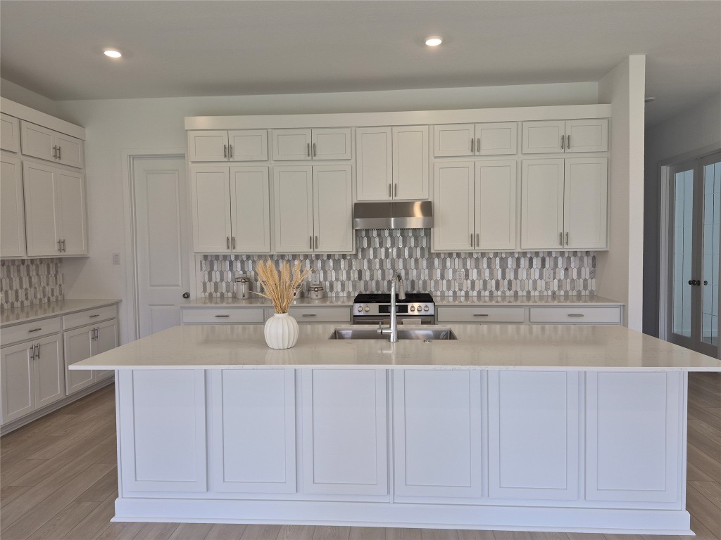 31007 Golden Felipe Street Fulshear, TX 77441 - Photo 6 of 19 a kitchen with a white cabinets and sink