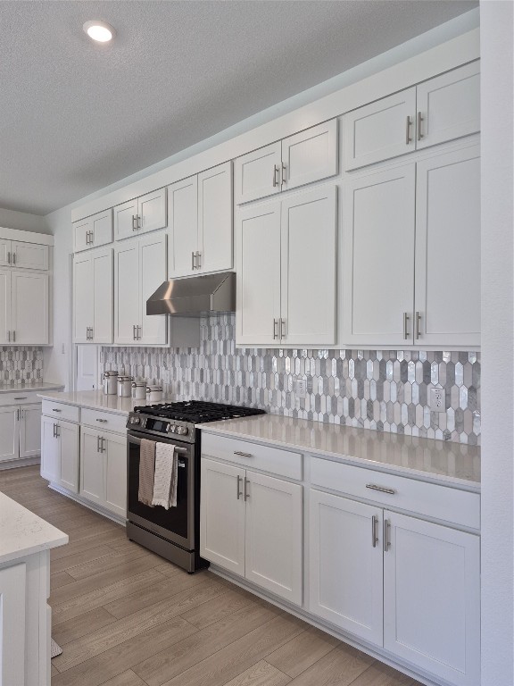 31007 Golden Felipe Street Fulshear, TX 77441 - Photo 9 of 19 a kitchen with granite countertop white cabinets and white appliances