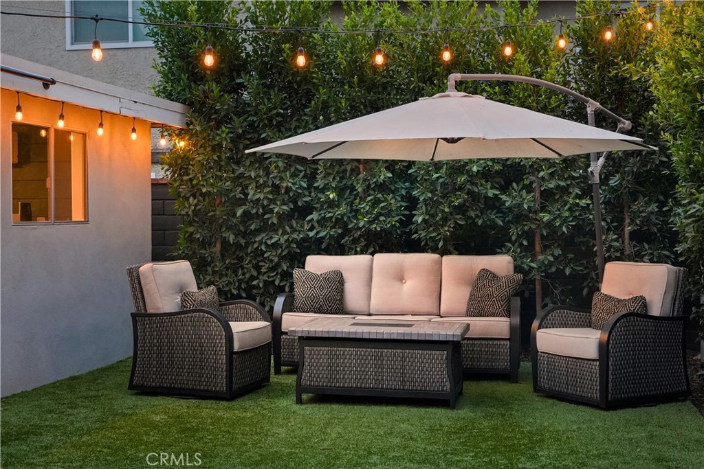 2028 Chesson Street Duarte, CA 91010 - Photo 45 of 66 patio area with string lights and ficus hedges