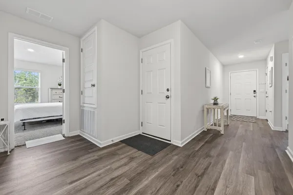 a kitchen with kitchen island granite countertop a sink stainless steel appliances and white cabinets