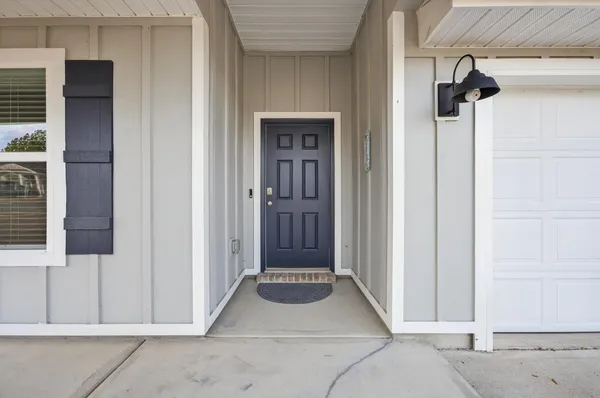 a kitchen with stainless steel appliances kitchen island granite countertop a stove a sink a microwave a dining table and chairs with wooden floor