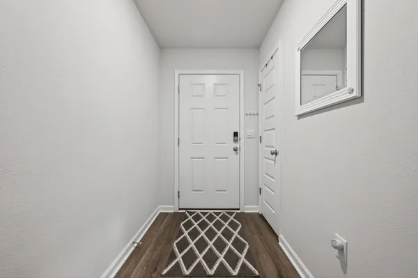 a dining room with stainless steel appliances kitchen island granite countertop a table chairs and a refrigerator