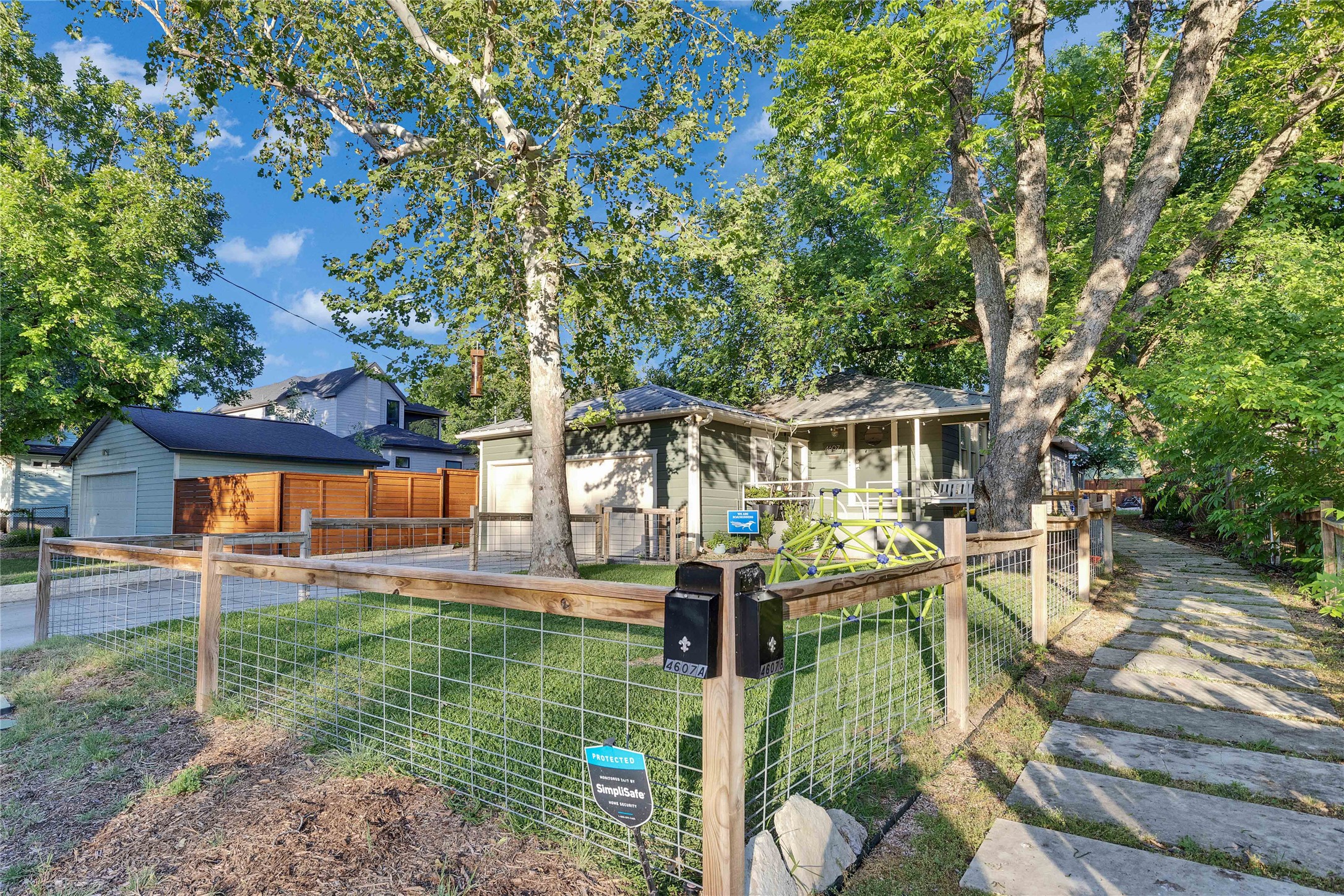 4607 Evans Avenue, Unit B Austin, TX 78751 - Photo 34 of 34 Fenced front yard featuring a manicured lawn, established shade trees, and a concrete paver walkway