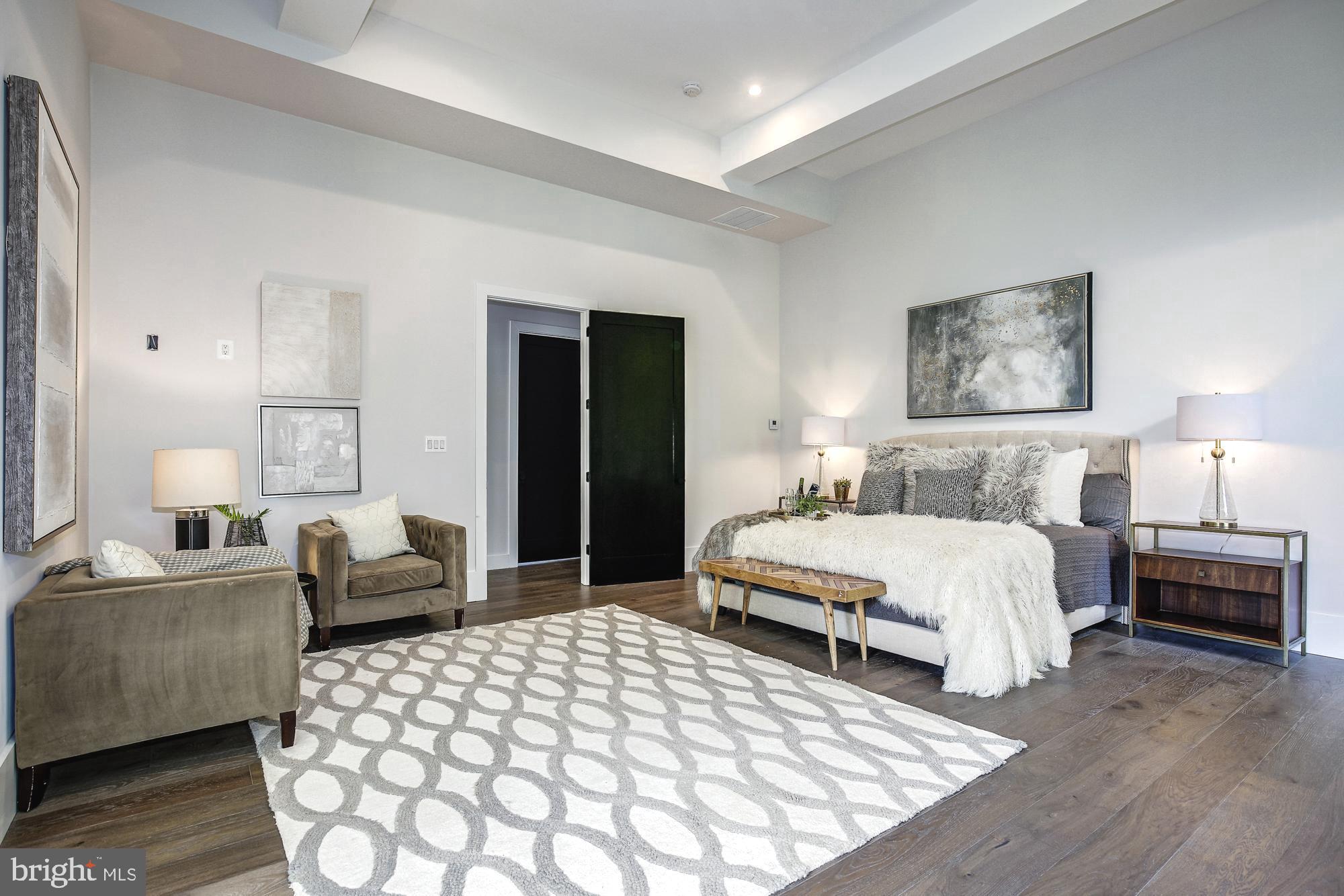 6160 Hardy Drive McLean, VA 22101 - Photo 16 of 41 a spacious bedroom with a bed and a couch