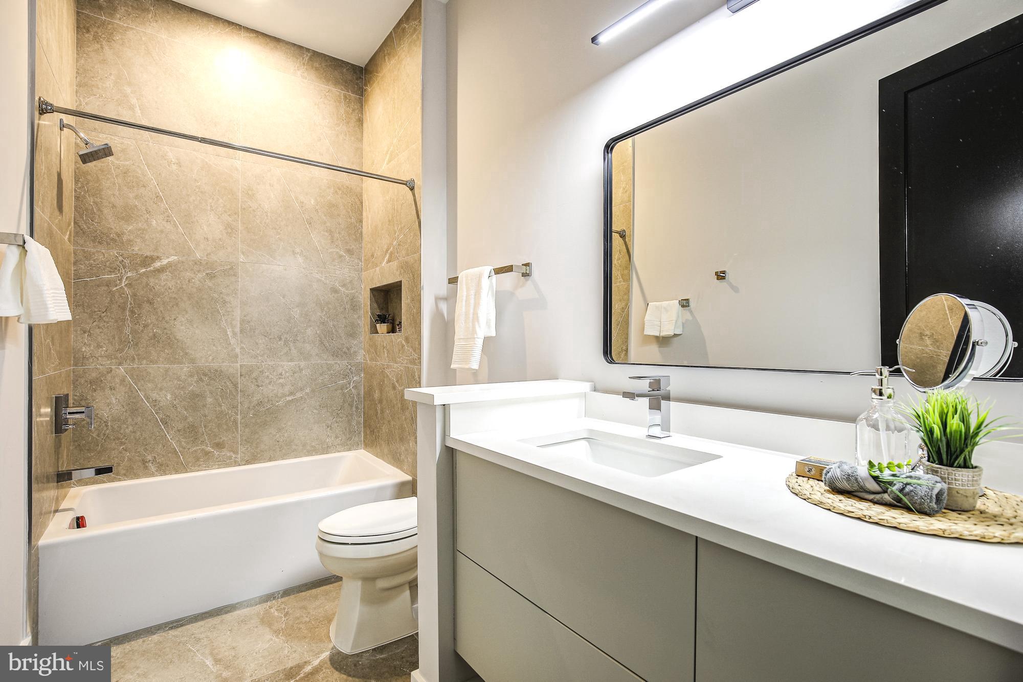 6160 Hardy Drive McLean, VA 22101 - Photo 26 of 41 a bathroom with a sink a toilet and a bathtub