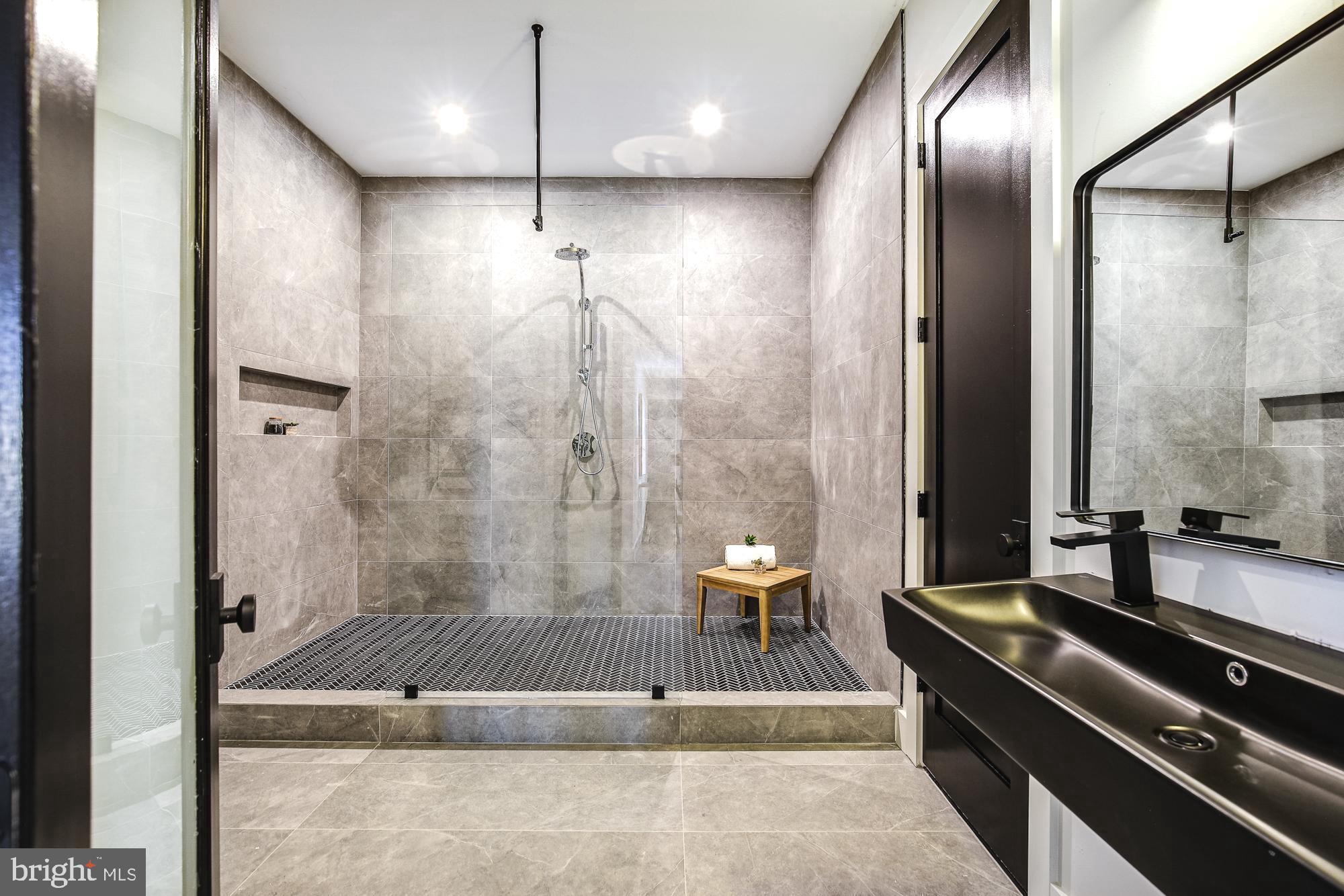 6160 Hardy Drive McLean, VA 22101 - Photo 33 of 41 a spacious bathroom with a granite countertop sink a toilet and shower