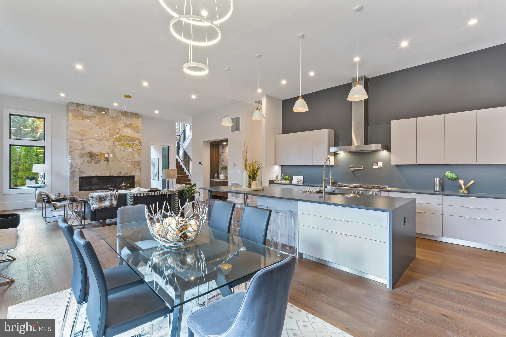 6160 Hardy Drive McLean, VA 22101 - Photo 9 of 41 a large kitchen with a dining table chairs sink and wooden floor