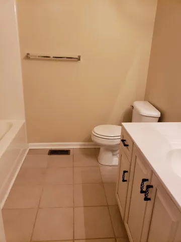 a bathroom with a toilet and a tub