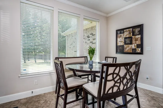 a view of a dining room with furniture and windows
