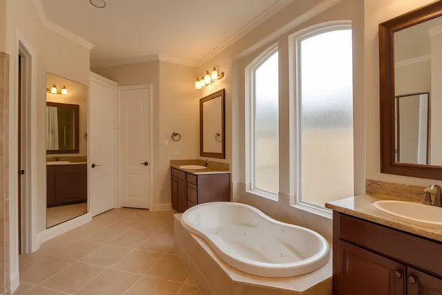 a bathroom with a tub sink and mirror