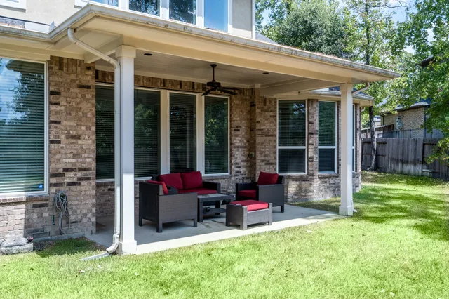 a view of a house with a backyard and a patio