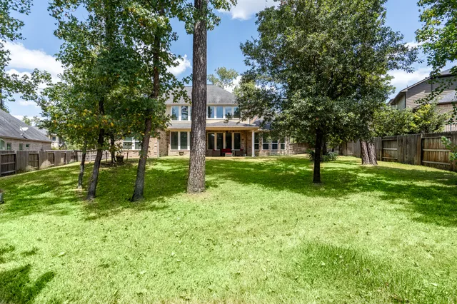 a view of a house with a backyard