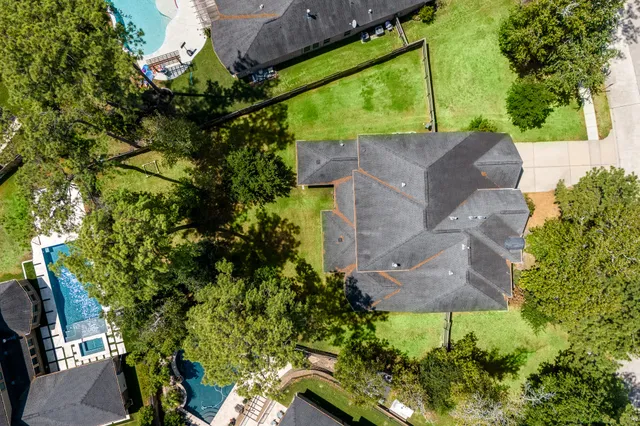 an aerial view of house with yard and outdoor seating