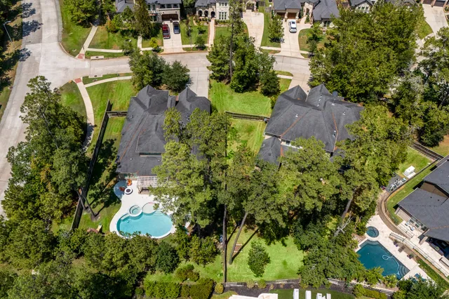 an aerial view of a house with a yard and lake view