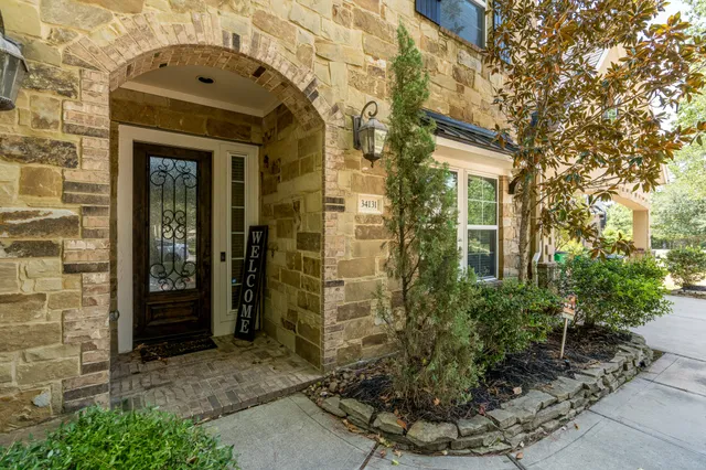 a view of a brick house with potted plants
