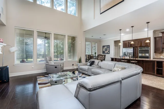 a living room with furniture and large windows