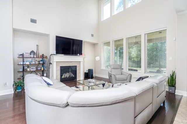 a living room with furniture fireplace and a flat screen tv