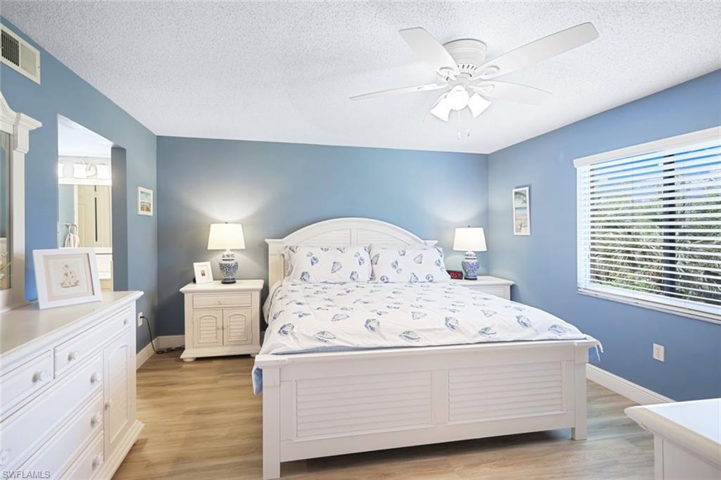 3041 Sandpiper Bay Circle, Unit H203 Naples, FL 34112 - Photo 11 of 23 a living room with furniture and chandelier