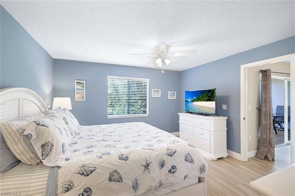 3041 Sandpiper Bay Circle, Unit H203 Naples, FL 34112 - Photo 12 of 23 a bedroom with a large bed and a tv