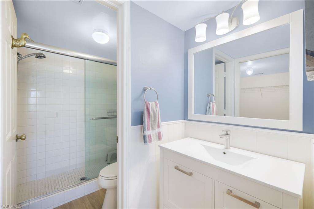 3041 Sandpiper Bay Circle, Unit H203 Naples, FL 34112 - Photo 13 of 23 a bathroom with a sink toilet and shower