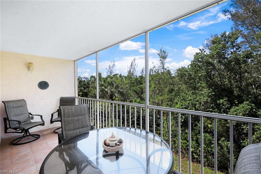 3041 Sandpiper Bay Circle, Unit H203 Naples, FL 34112 - Photo 17 of 23 a view of a chairs and tables in patio