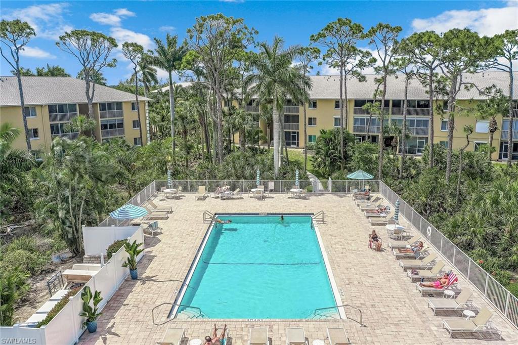 3041 Sandpiper Bay Circle, Unit H203 Naples, FL 34112 - Photo 20 of 23 a view of swimming pool with a patio