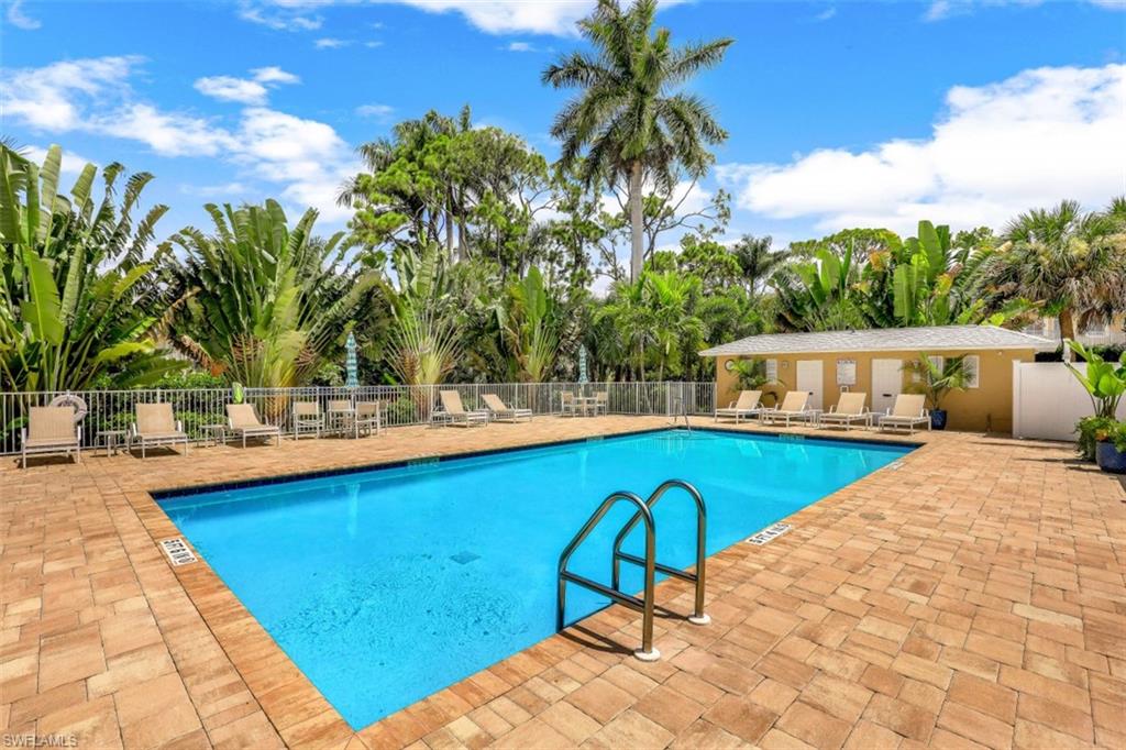 3041 Sandpiper Bay Circle, Unit H203 Naples, FL 34112 - Photo 21 of 23 a view of swimming pool with chairs