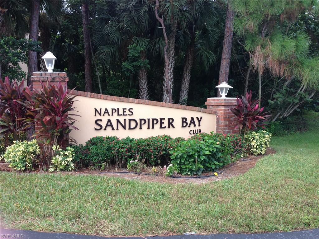 3041 Sandpiper Bay Circle, Unit H203 Naples, FL 34112 - Photo 23 of 23 a sign of golf club on a wall under a tree