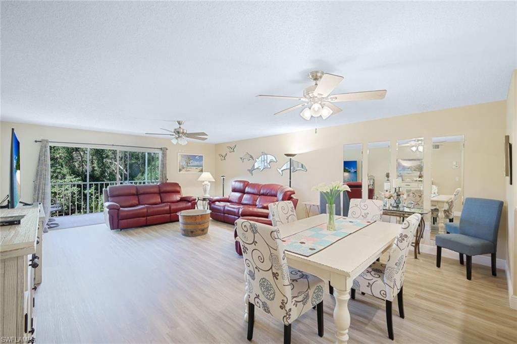 3041 Sandpiper Bay Circle, Unit H203 Naples, FL 34112 - Photo 9 of 23 a outdoor space with furniture and wooden floor