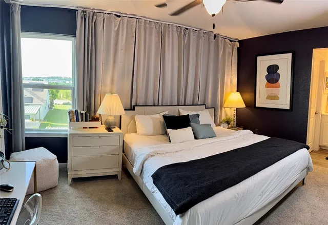 a bedroom with a bed and a window