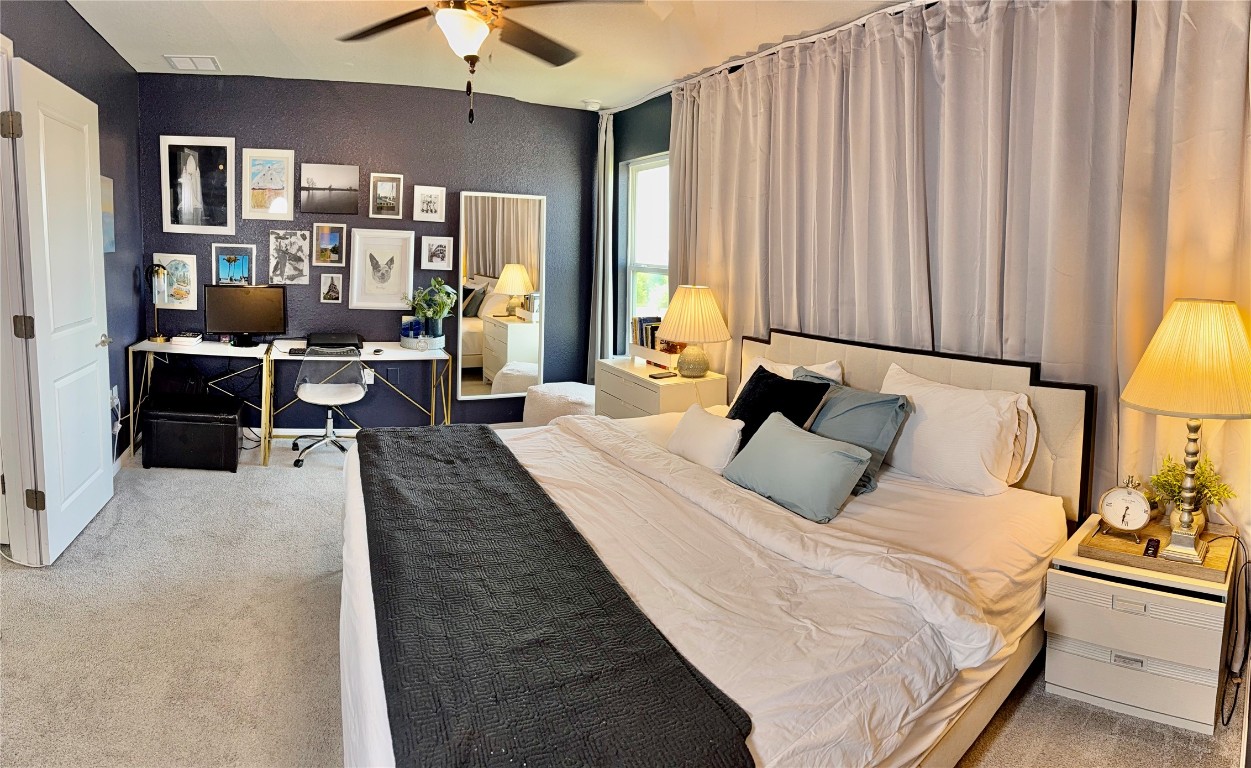 16710 Sonoma Breeze Drive Manor, TX 78653 - Photo 12 of 16 a bed room with a bed window and a chandelier