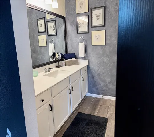 a bathroom with a sink a mirror and a vanity