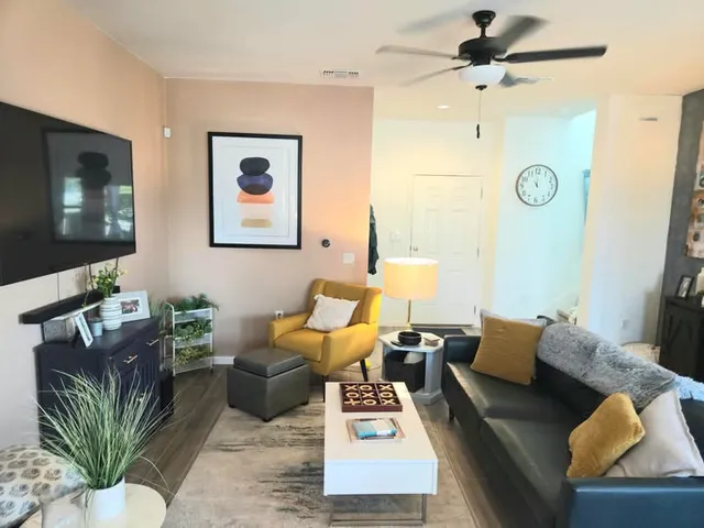 a living room with furniture and a flat screen tv