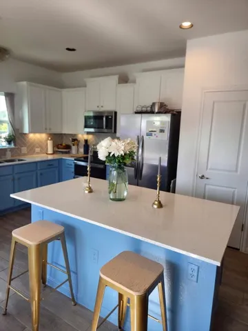 a dining table chairs and a refrigerator