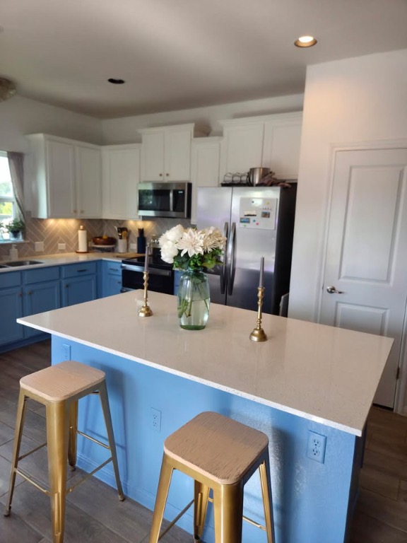 16710 Sonoma Breeze Drive Manor, TX 78653 - Photo 9 of 16 a dining table chairs and a refrigerator
