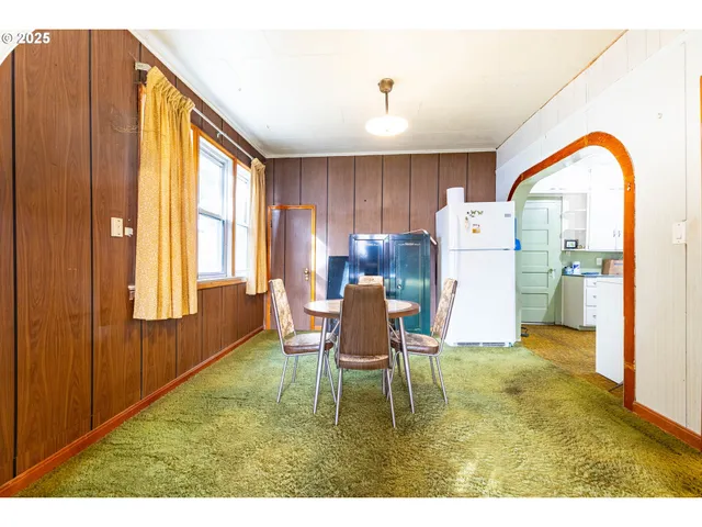 a living room with furniture windows and a table