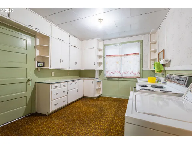 a kitchen with kitchen island sink stove and cabinets