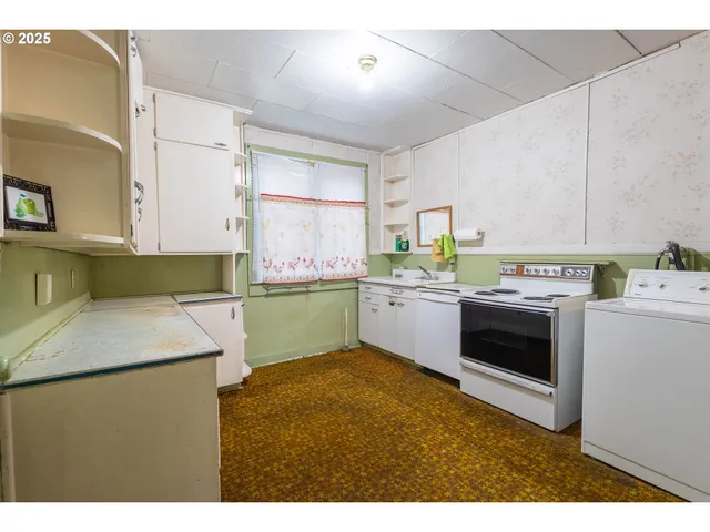 a kitchen with a sink a stove and cabinets