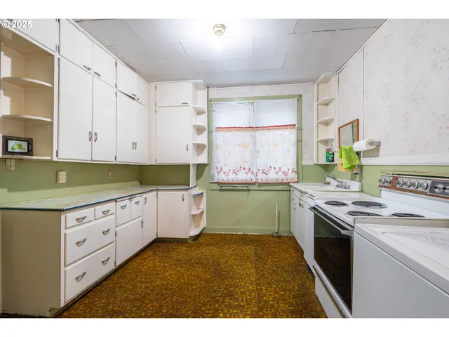 a kitchen with granite countertop a sink and cabinets