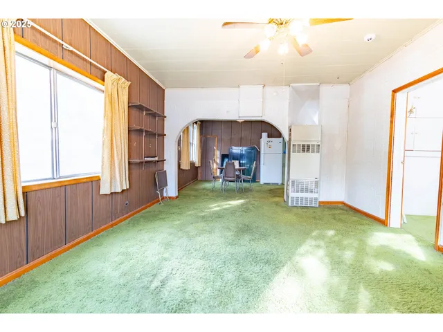 a view of a livingroom with furniture and a window