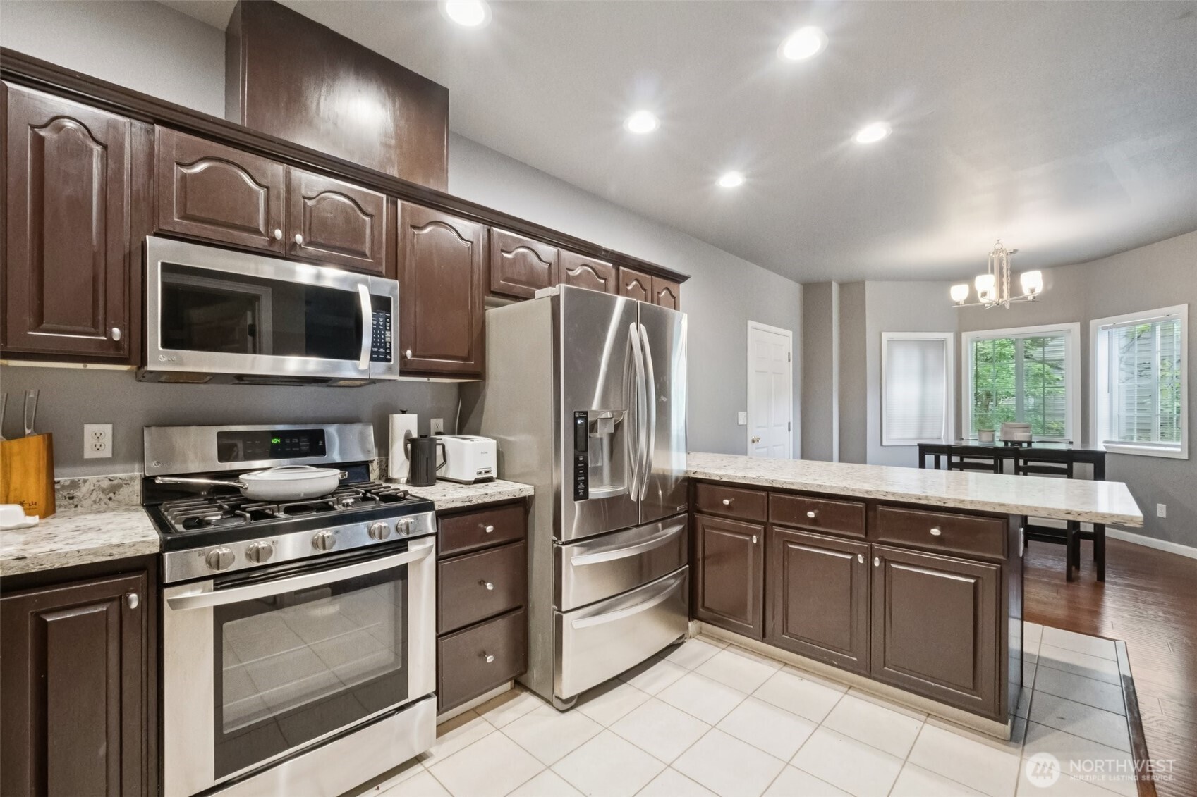 2750 Diamond Loop, Unit E Milton, WA 98354 - Photo 11 of 29 a kitchen with stainless steel appliances granite countertop a stove cabinets and microwave