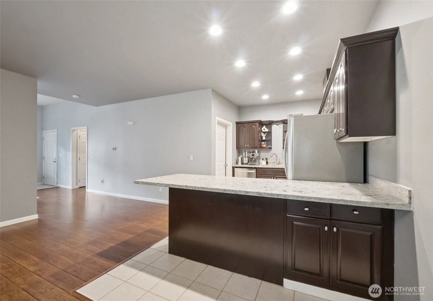 2750 Diamond Loop, Unit E Milton, WA 98354 - Photo 13 of 29 a kitchen with stainless steel appliances granite countertop a sink and a stove