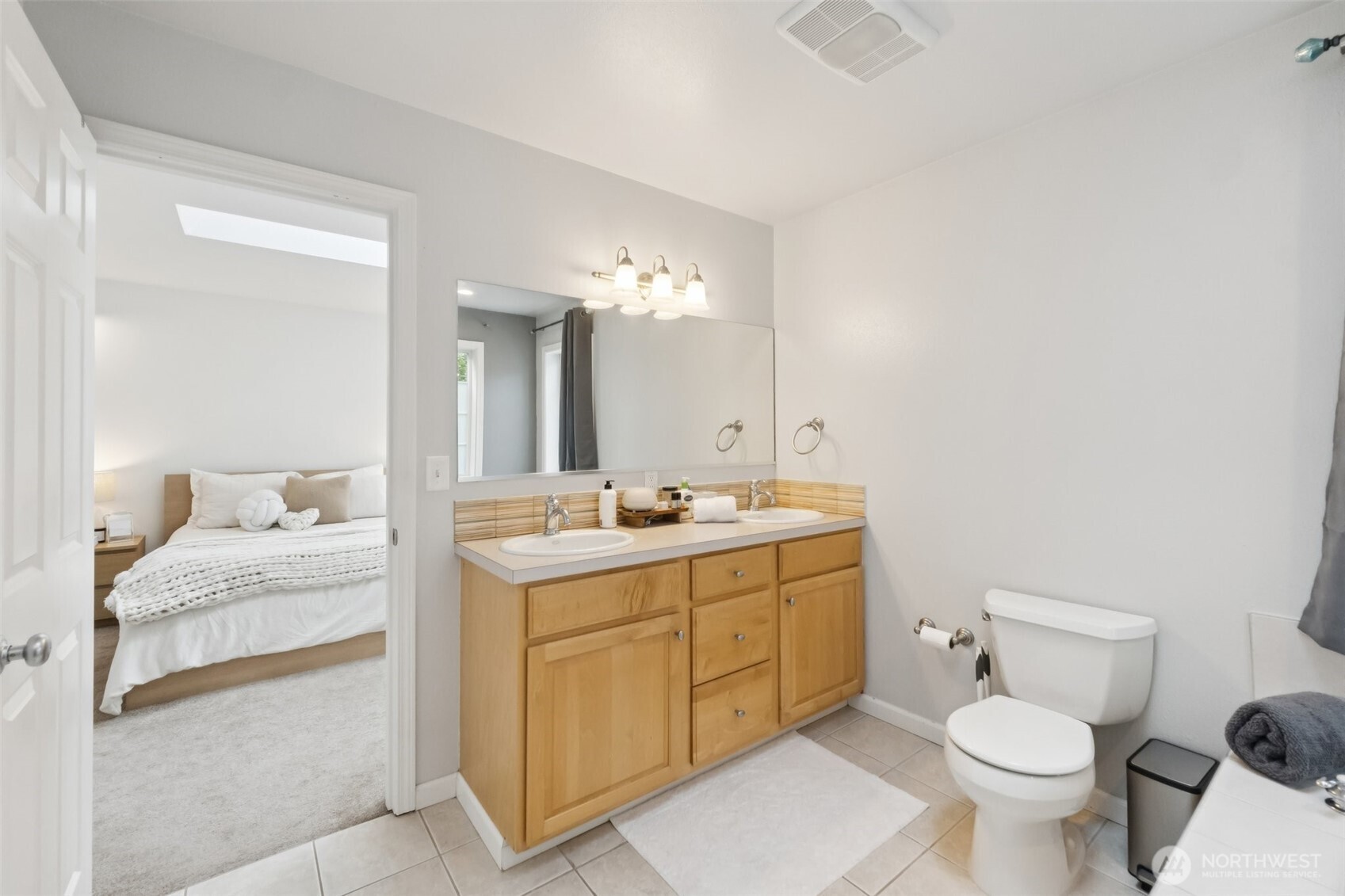 2750 Diamond Loop, Unit E Milton, WA 98354 - Photo 17 of 29 a bathroom with a toilet sink and mirror