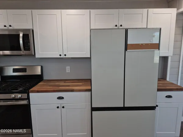 a white refrigerator freezer sitting in a kitchen
